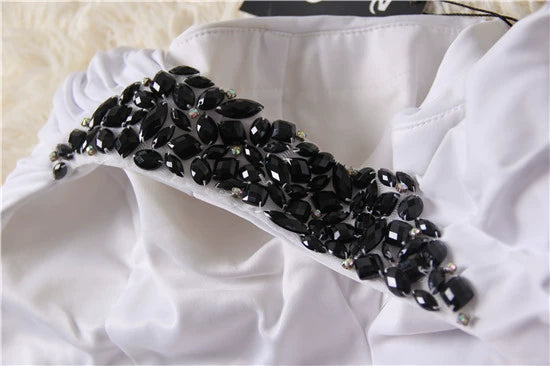 Mini abito da sera monospalla in maglia elasticizzata bianca