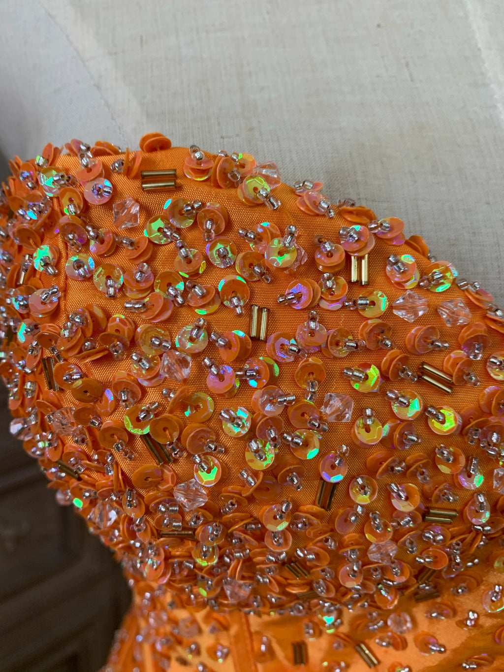 Orange taffeta strapless beaded evening gown