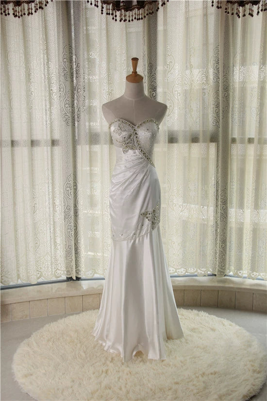 White brocade fishtail evening gown with back straps