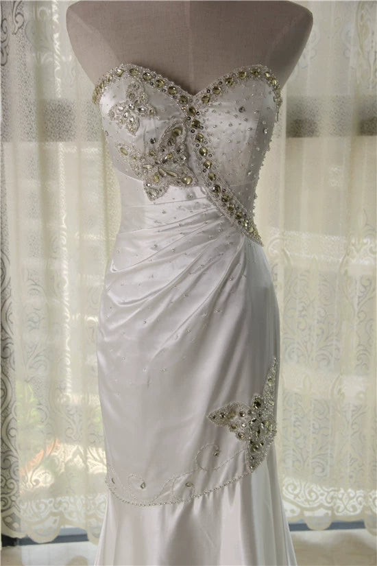 White brocade fishtail evening gown with back straps