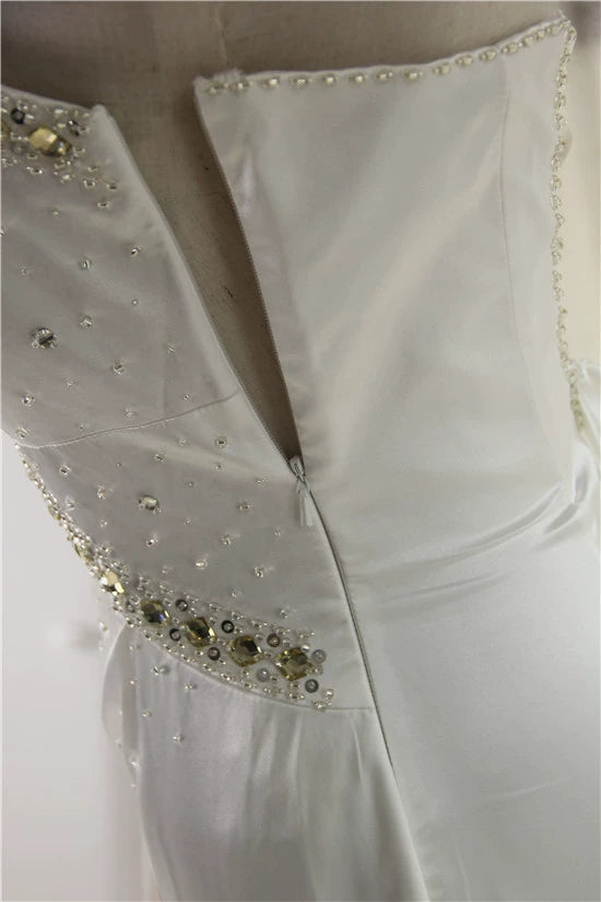 White brocade fishtail evening gown with back straps