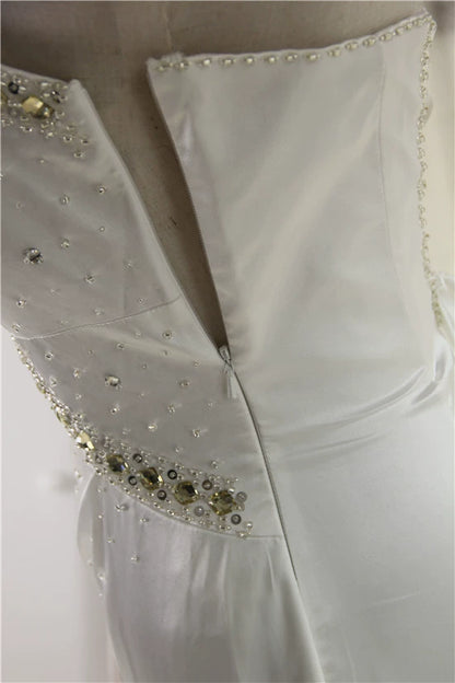White brocade fishtail evening gown with back straps