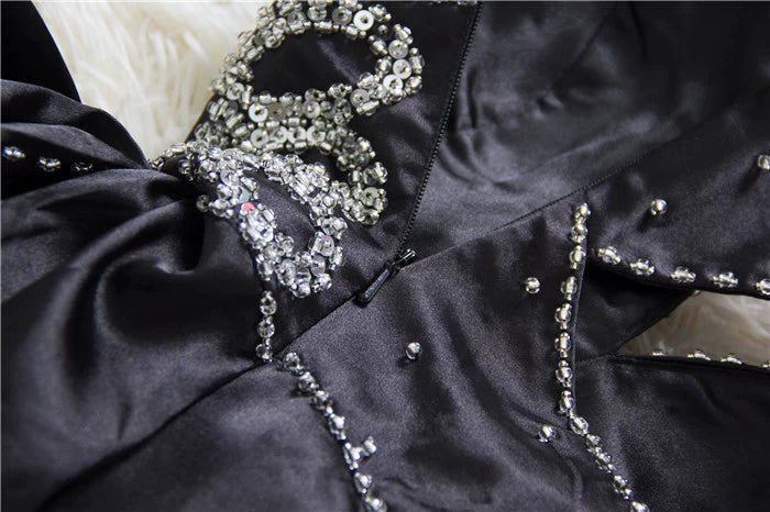 Black satin backless evening gown with ties