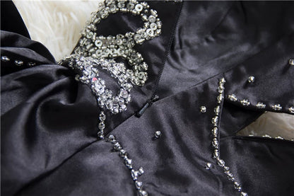 Black satin backless evening gown with ties