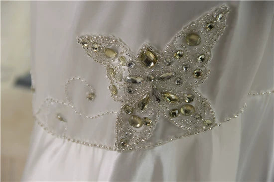 White brocade fishtail evening gown with back straps