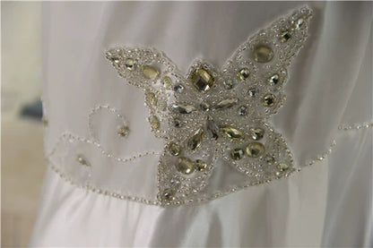 White brocade fishtail evening gown with back straps