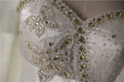 White brocade fishtail evening gown with back straps