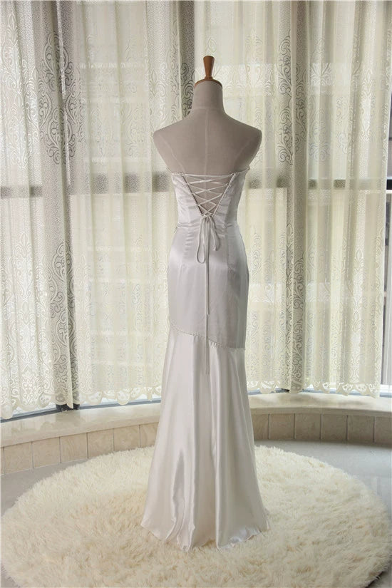 White brocade fishtail evening gown with back straps