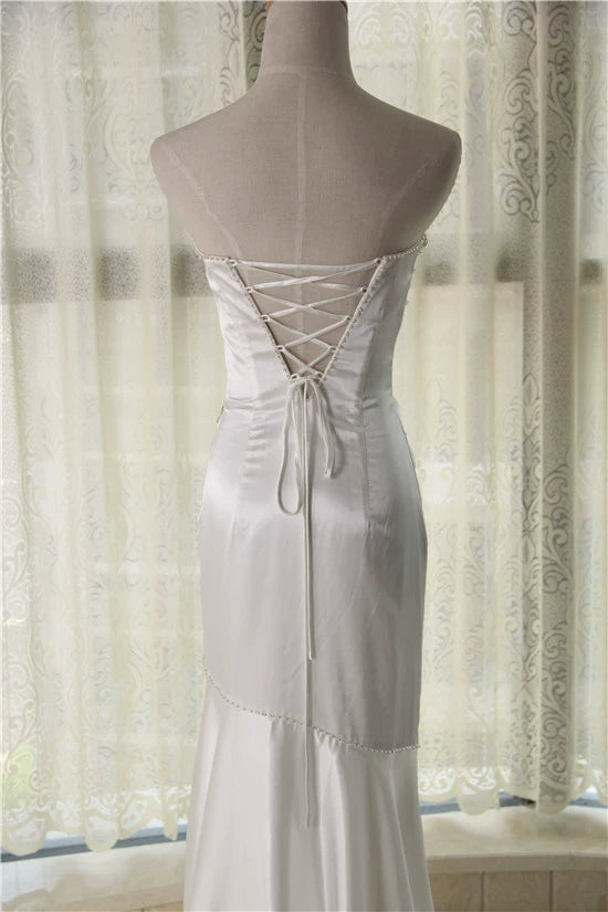 White brocade fishtail evening gown with back straps