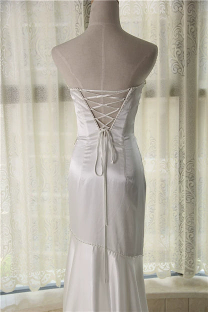 White brocade fishtail evening gown with back straps